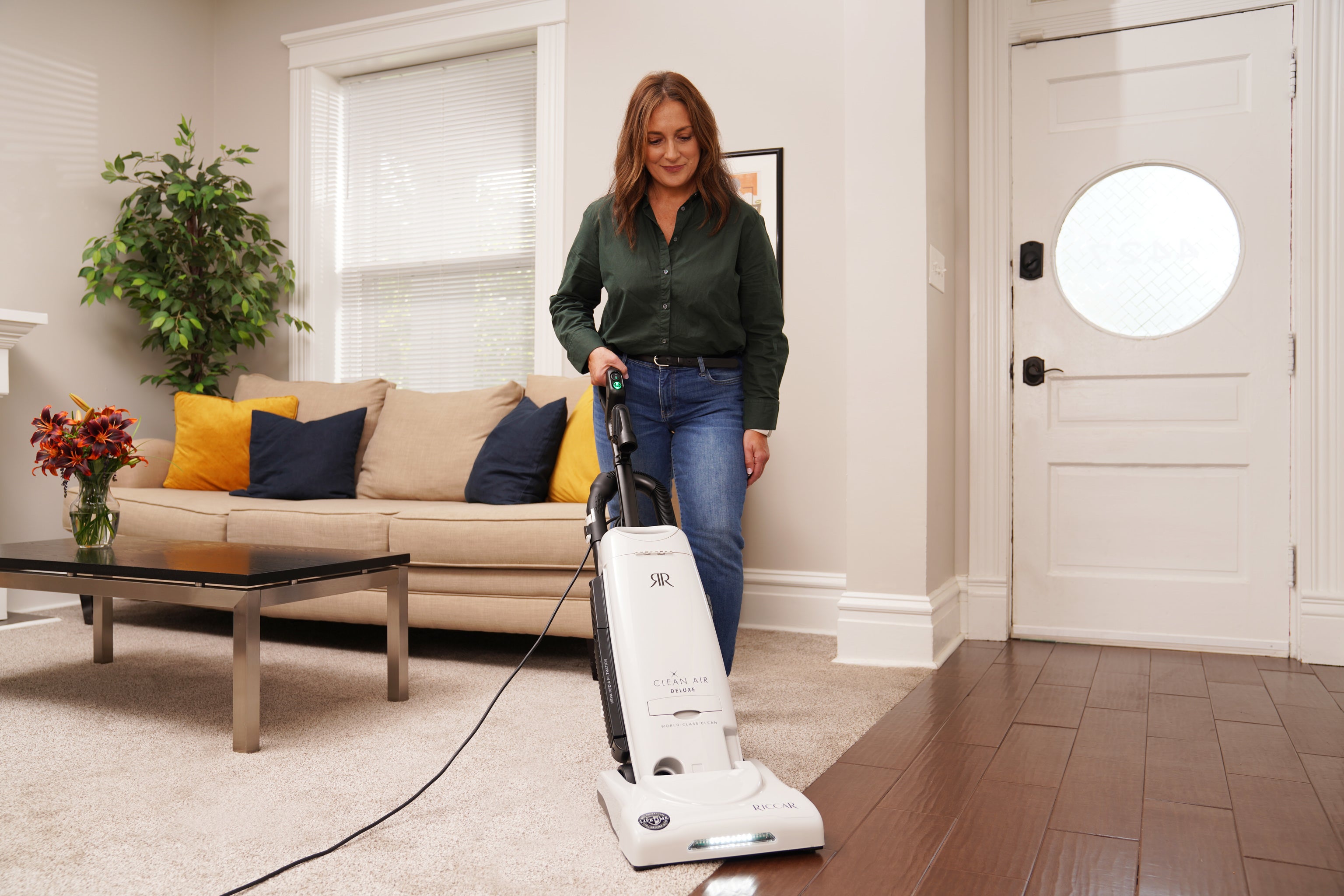 Woman using a vacuum cleaner in a living room.